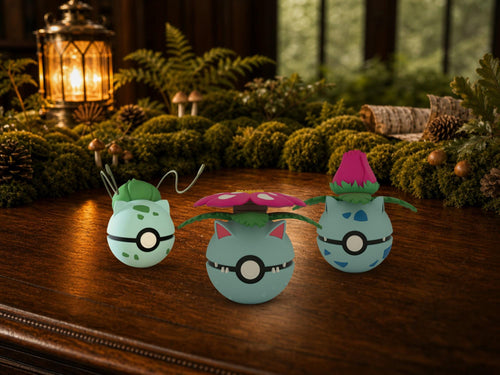 Bulbasaur, Ivysaur and Venusaur N3D Poké Balls on a woodland study desk, 3D printed Pokeball clicker evolution line