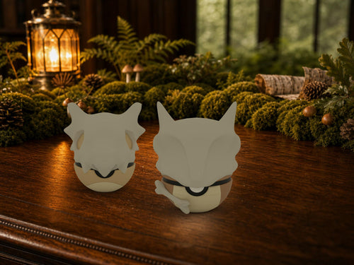 Cubone and Marowak N3D Poké Balls on a woodland study desk, 3D printed Pokeball clicker evolution line