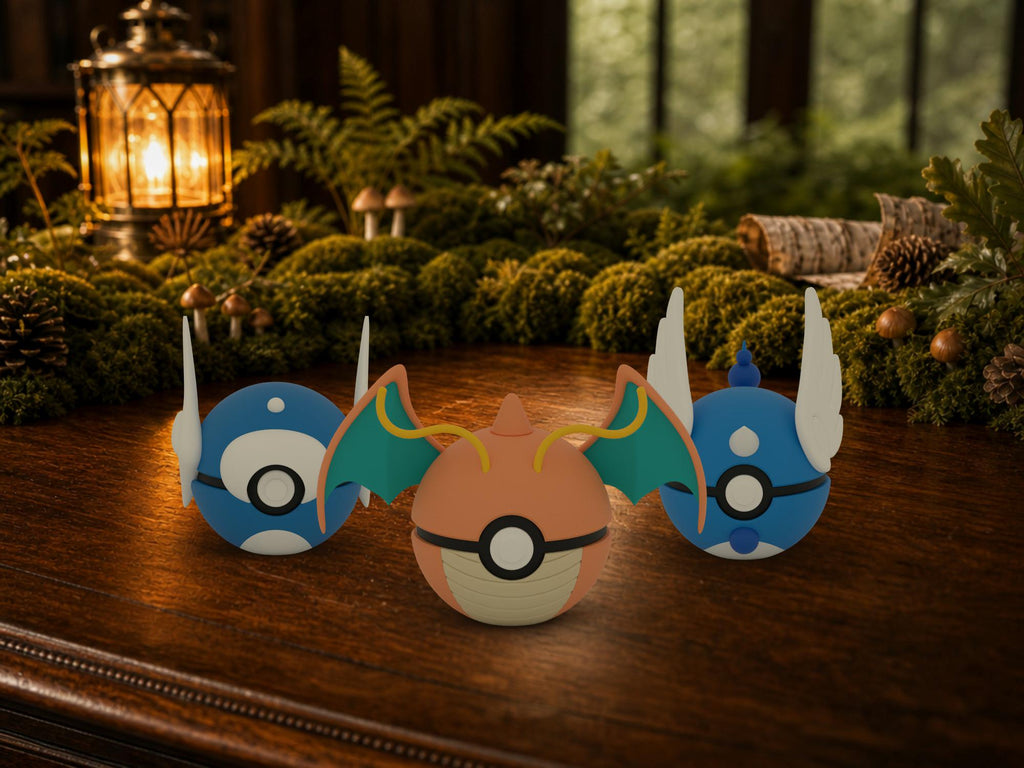 Dratini, Dragonair and Dragonite N3D Poké Balls on a woodland study desk, 3D printed Pokeball clicker evolution line