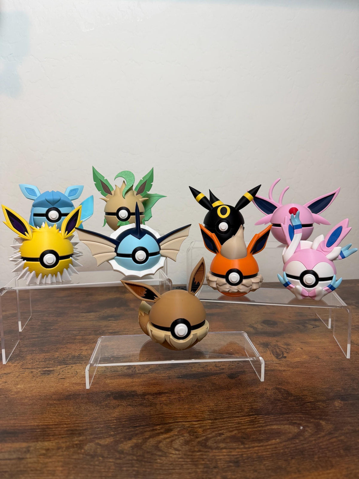 Real photo: all nine Eeveelution N3D Poké Balls, 3D printed, Eevee to Sylveon, on an acrylic display stand