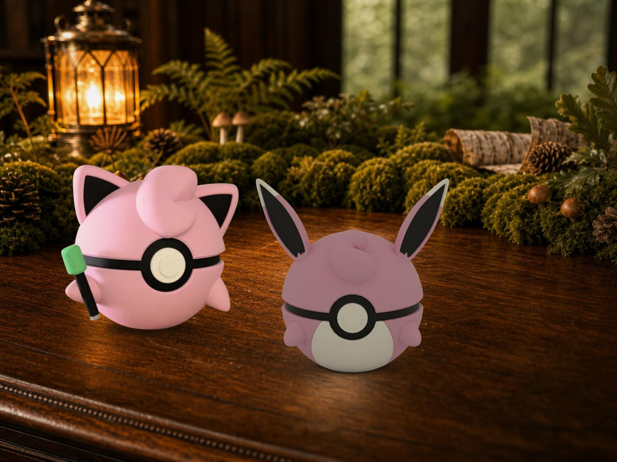 Jigglypuff and Wigglytuff N3D Poké Balls on a woodland study desk, 3D printed Pokeball clicker evolution line