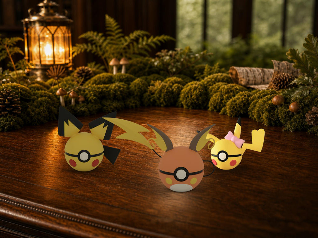 Pichu, Pikachu and Raichu N3D Poké Balls on a woodland study desk, 3D printed Pokeball clicker evolution line