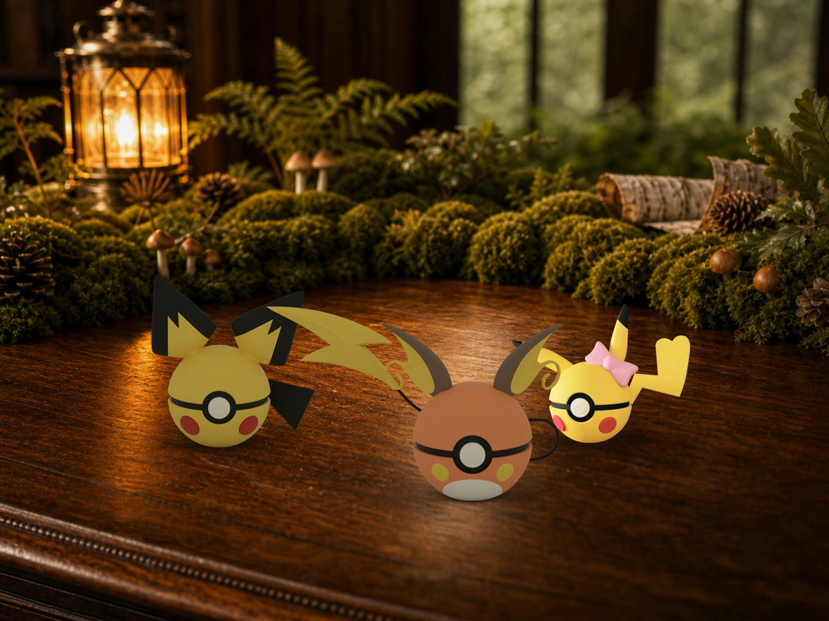 Pichu, Pikachu and Raichu N3D Poké Balls on a woodland study desk, 3D printed Pokeball clicker evolution line